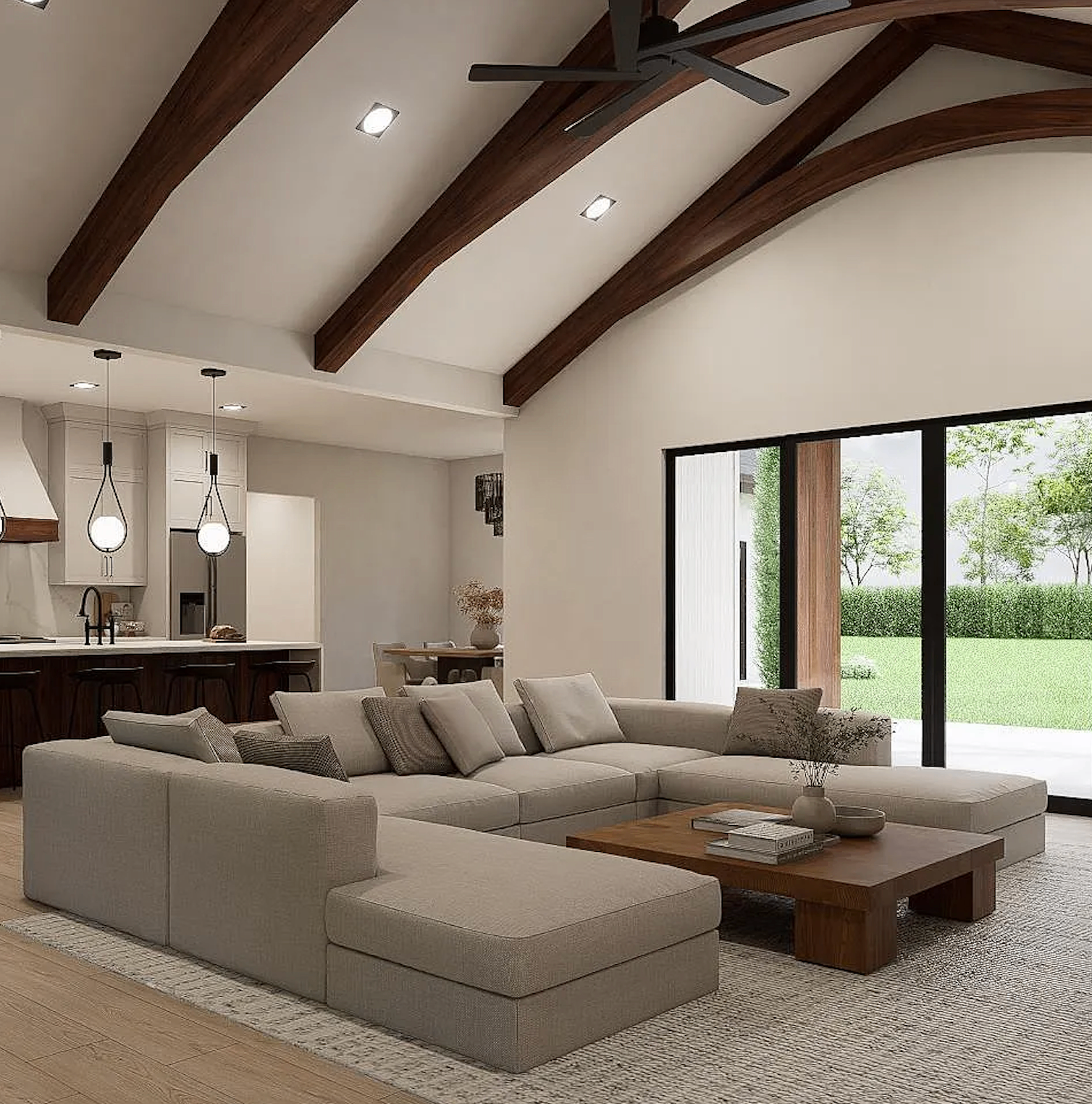 Luxury modern farmhouse great room with vaulted ceilings, exposed wood beams, open-concept kitchen and living area with floor-to-ceiling windows